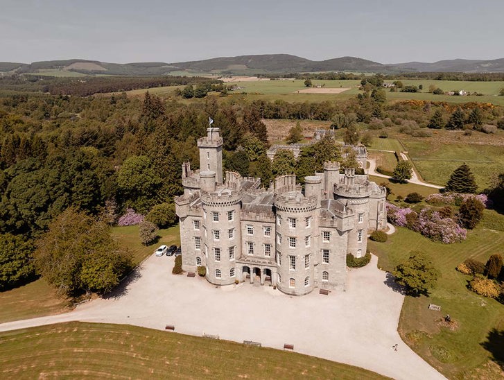 view of cluny castle from drone with surrounding land